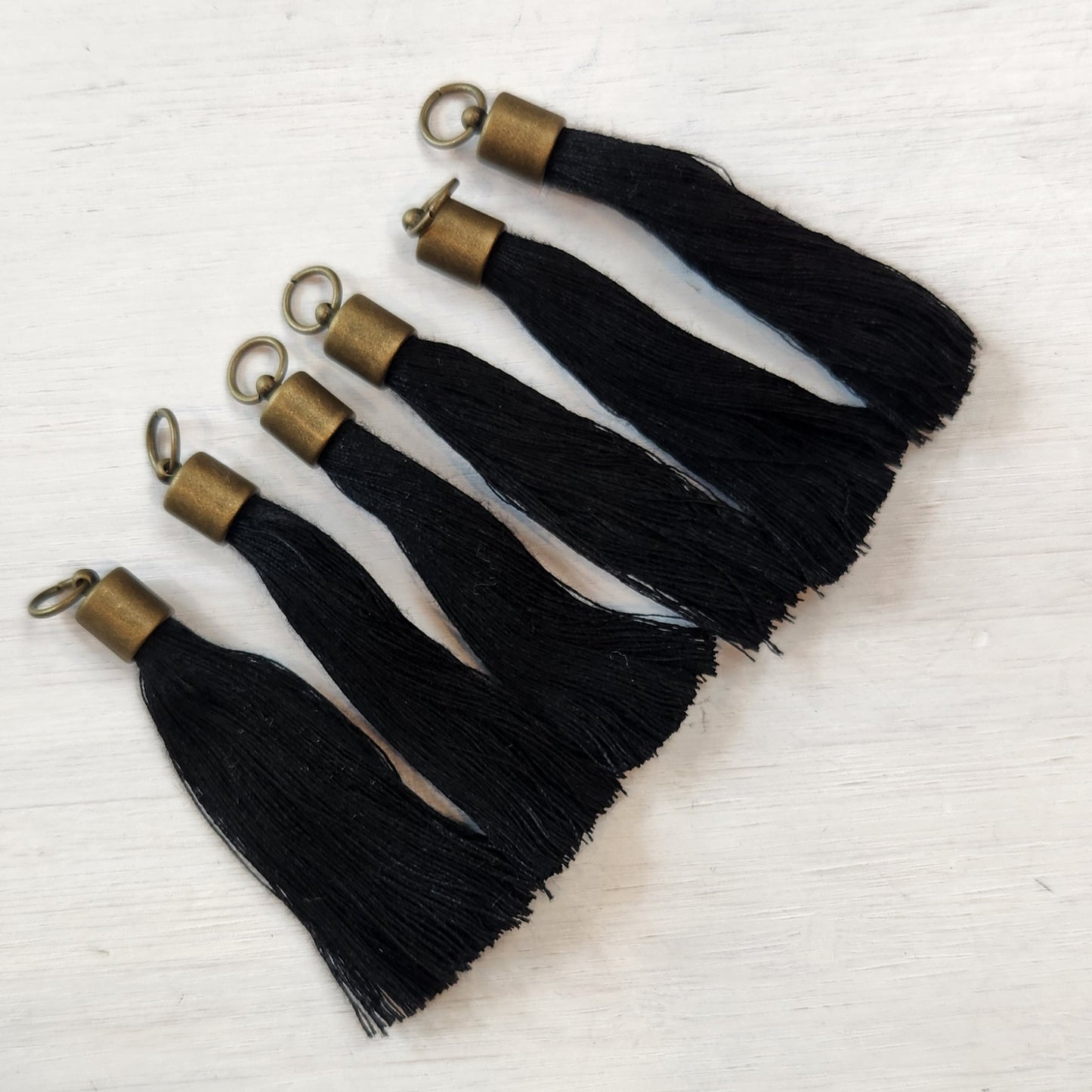 Anique brass tassel