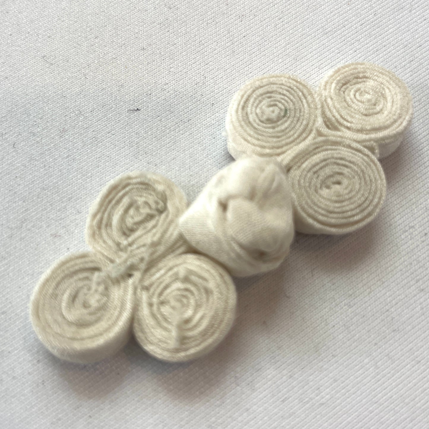 Ivory coiled frog closure