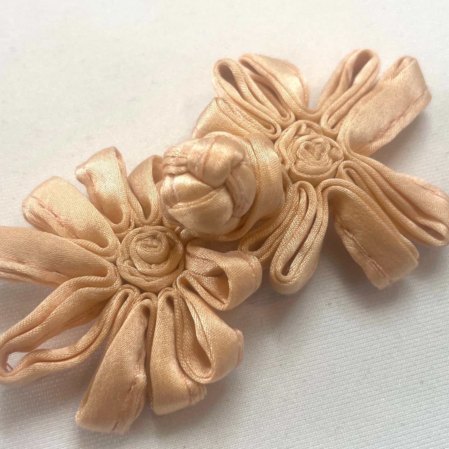 Peach satin frog closure