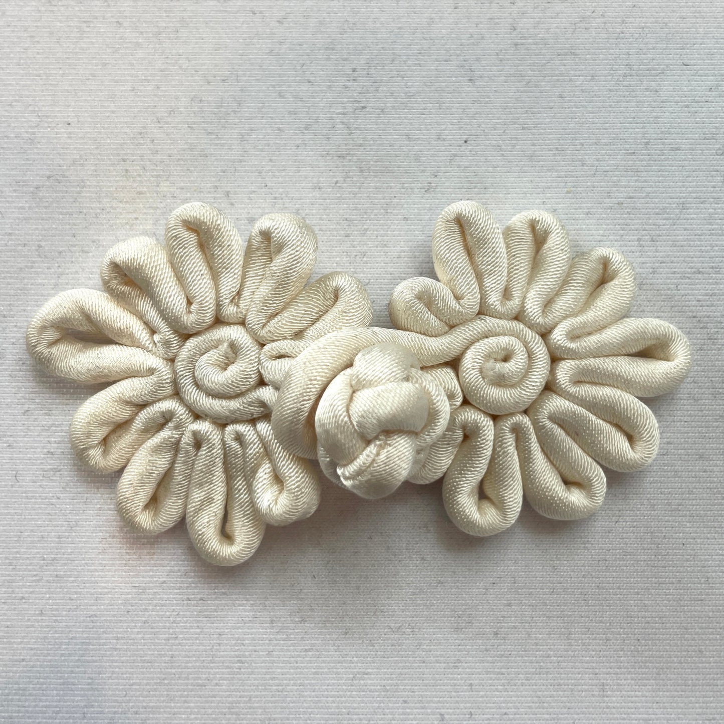 Cream sateen frog closure