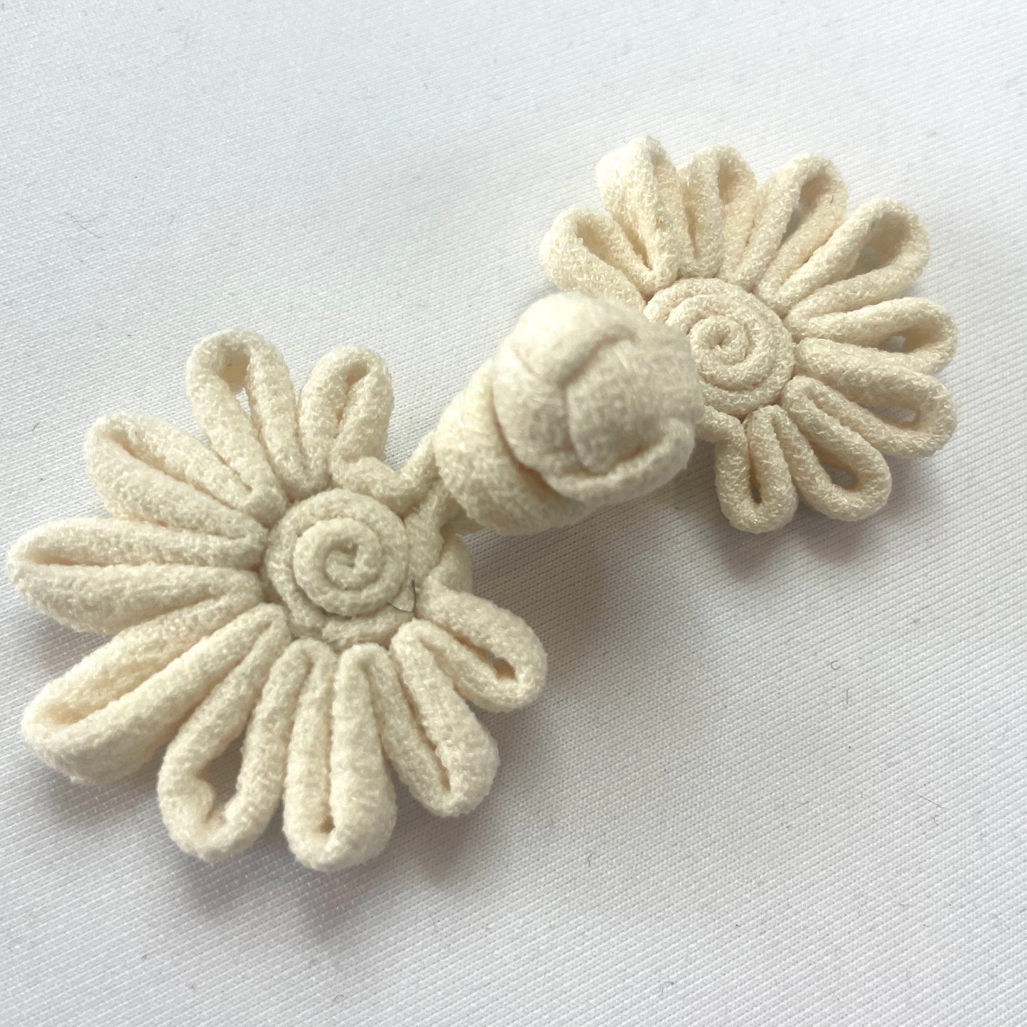 Cream crepe frog closure