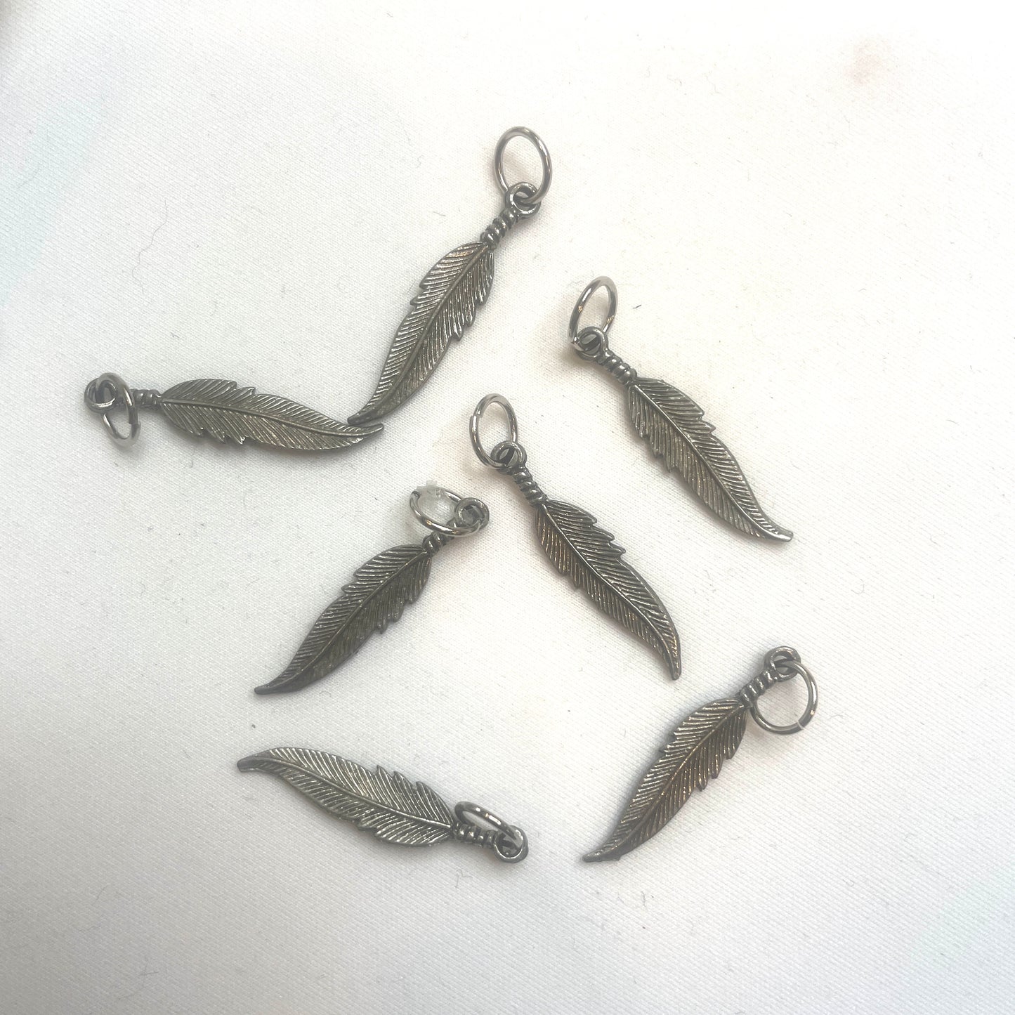 Silver feather charm