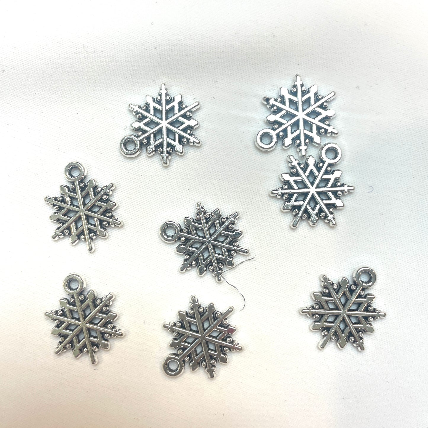 Silver snowflake charm