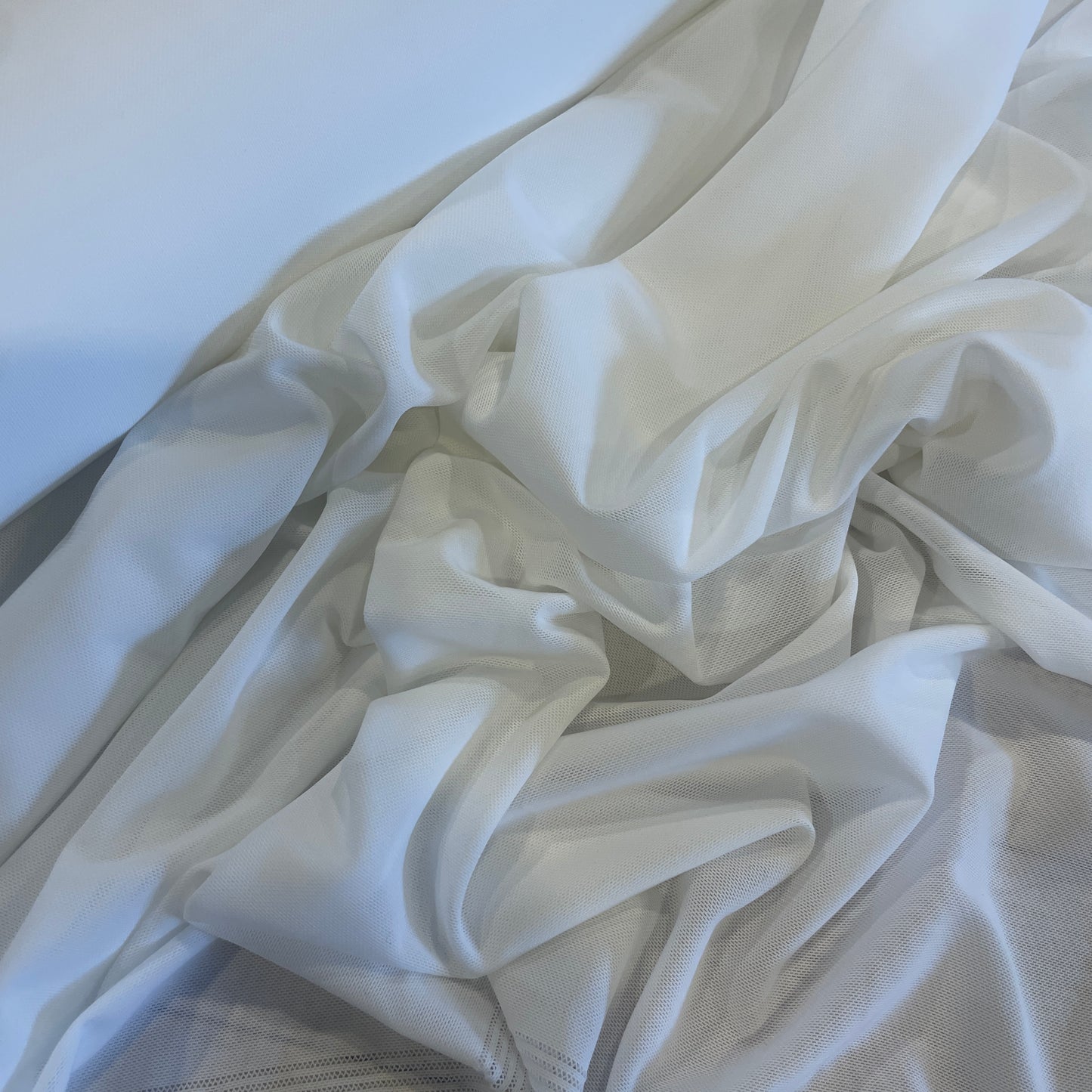 White athletic two way stretch mesh