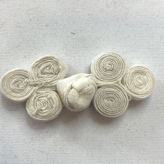 Ivory coiled frog closure