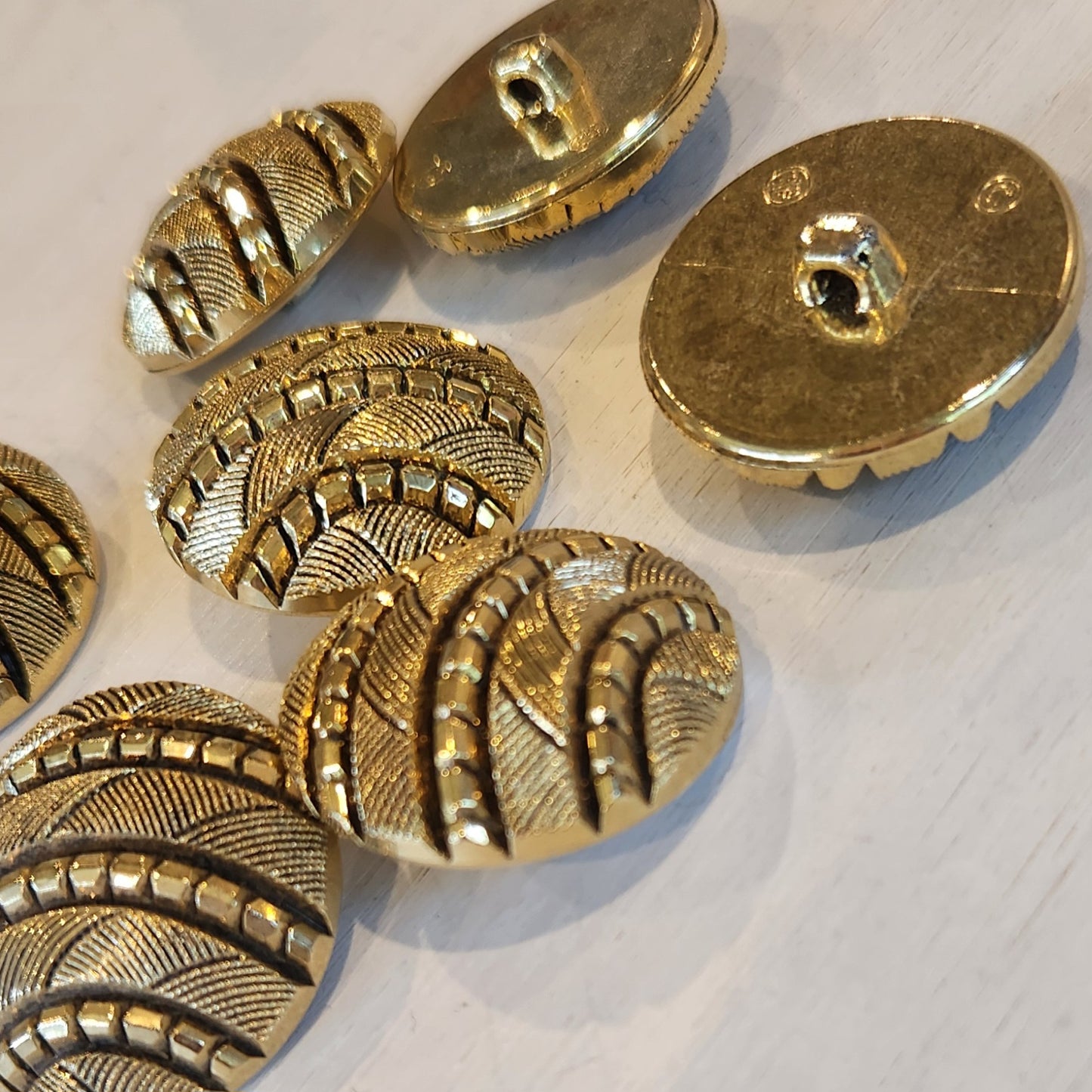 Cut gold and black button