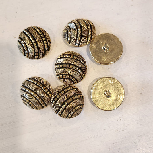 Cut gold and black button