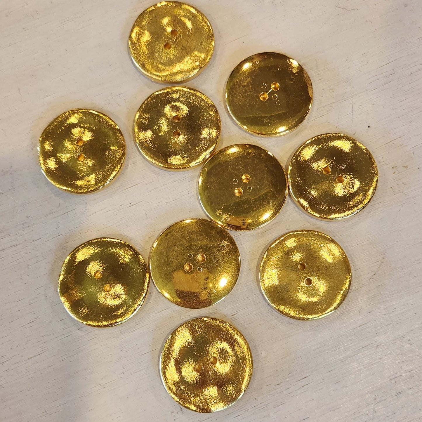 Melted gold button