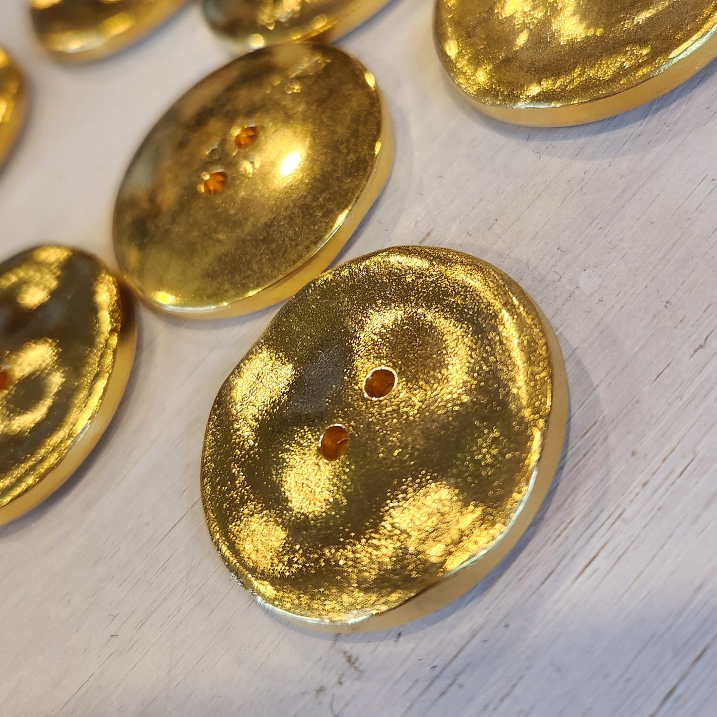 Melted gold button